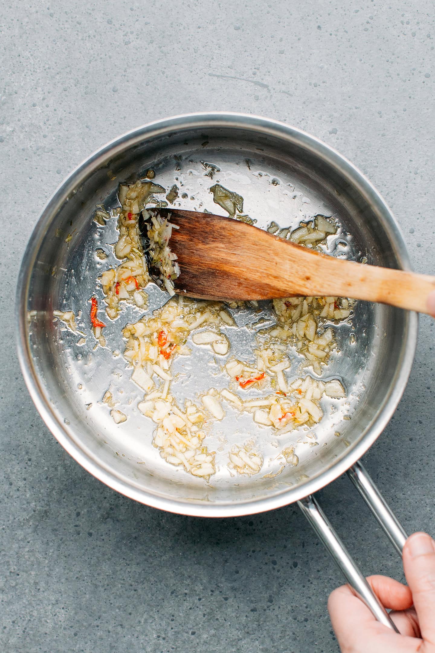 Sautéed garlic, lemongrass, and chili in a saucepan.