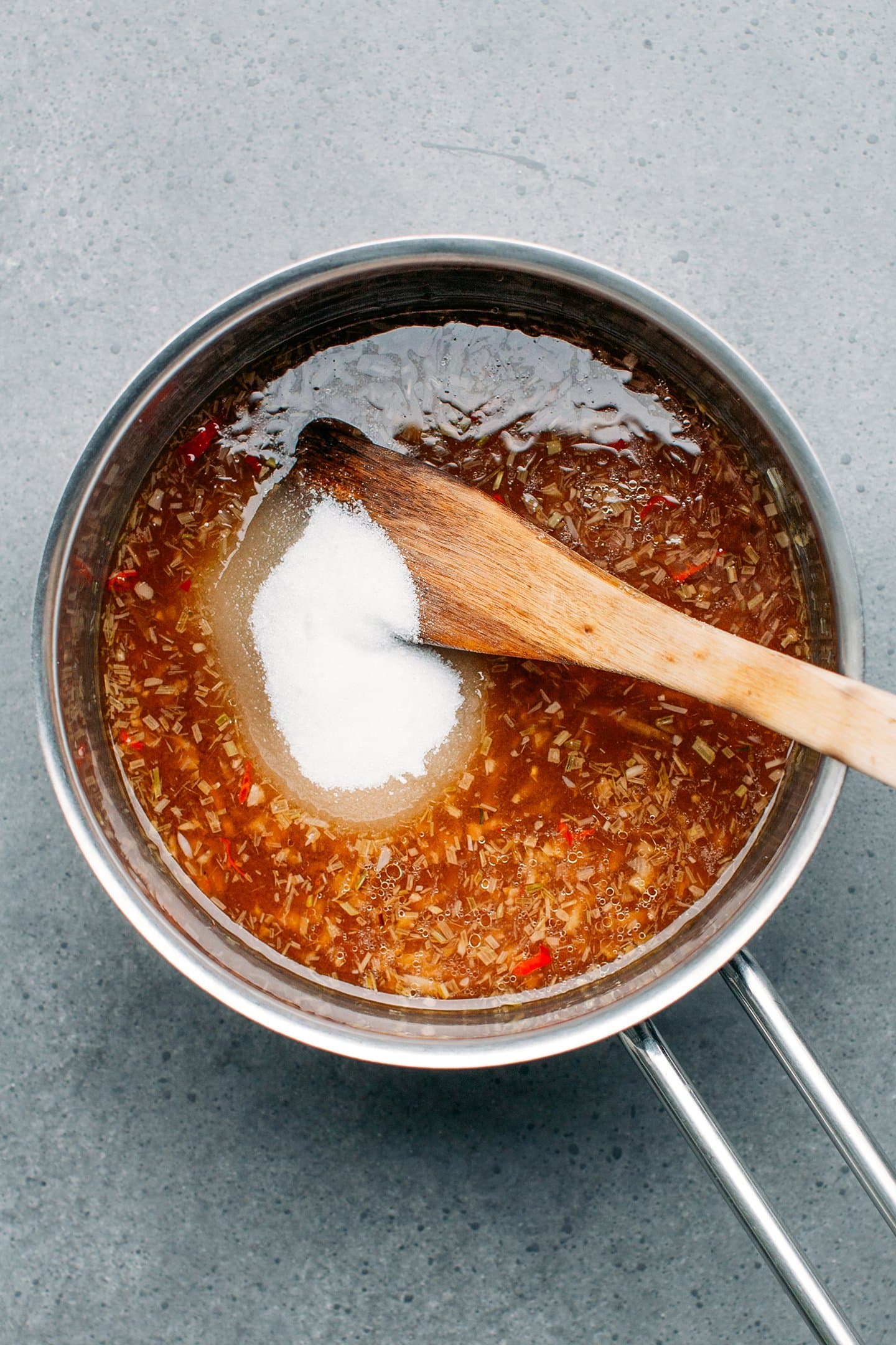 Tamarind sauce and sugar in a saucepan.