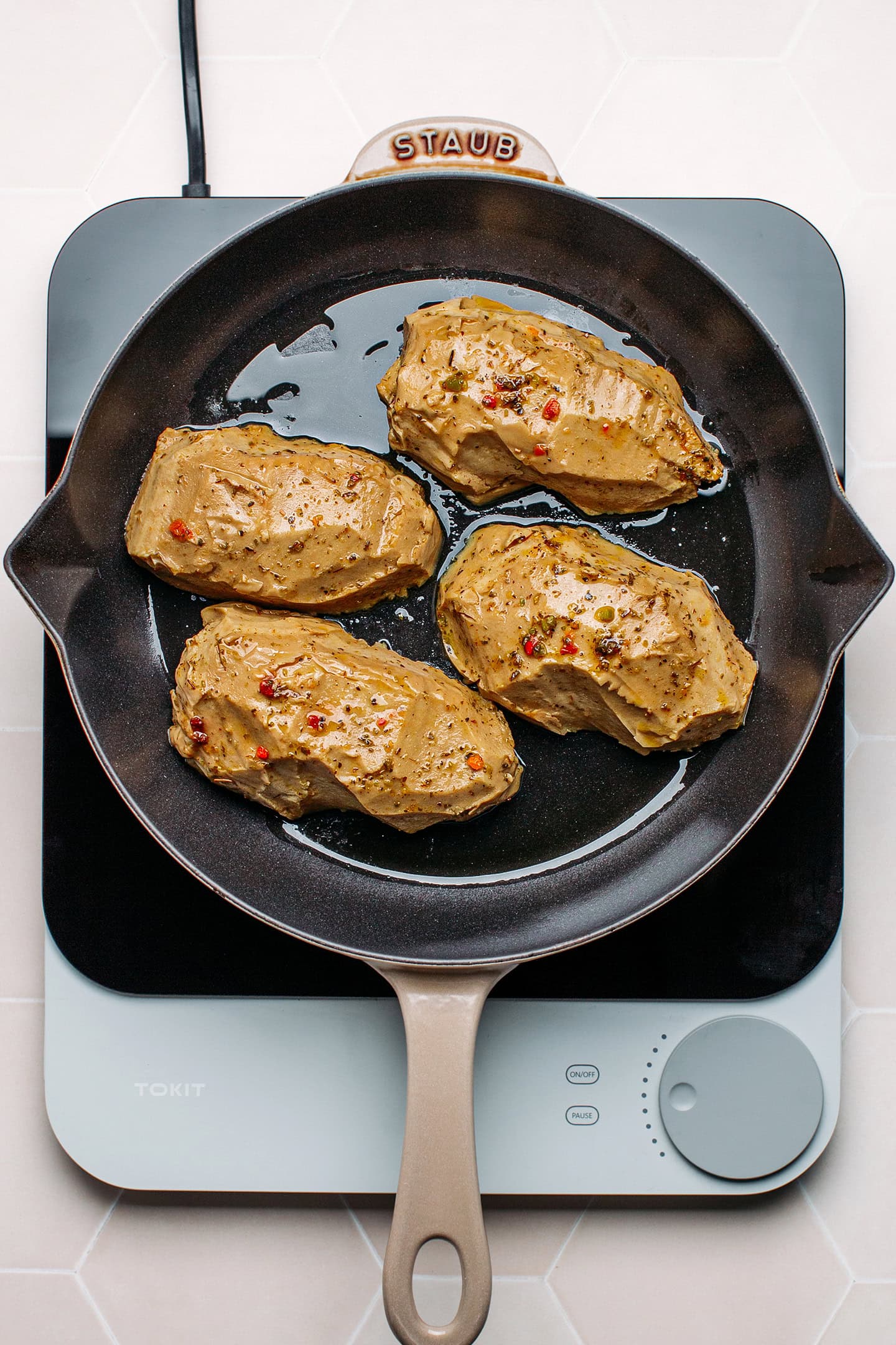 Grilled vegan chicken cutlets in a skillet.