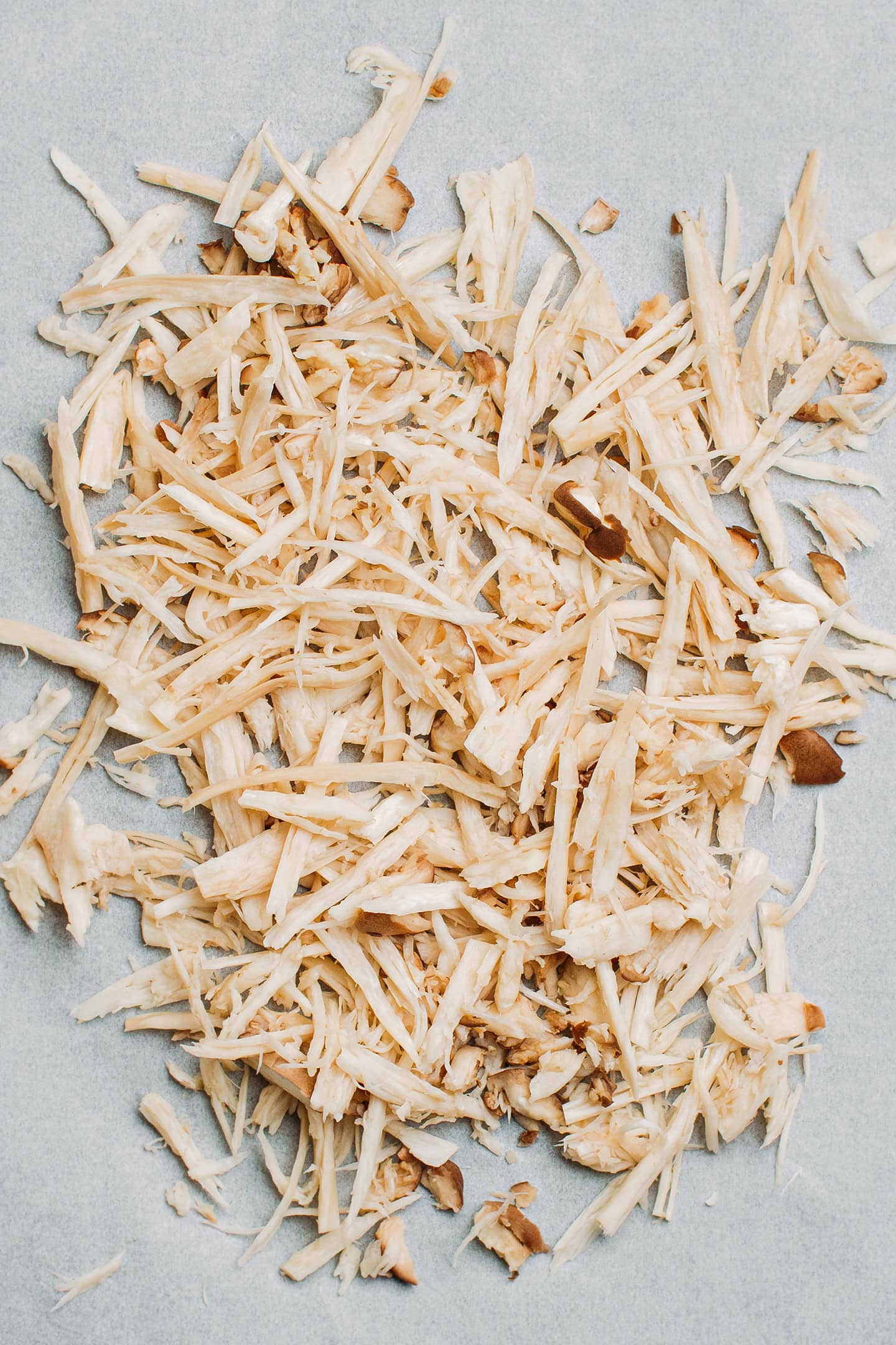 Shredded mushrooms on a baking sheet.