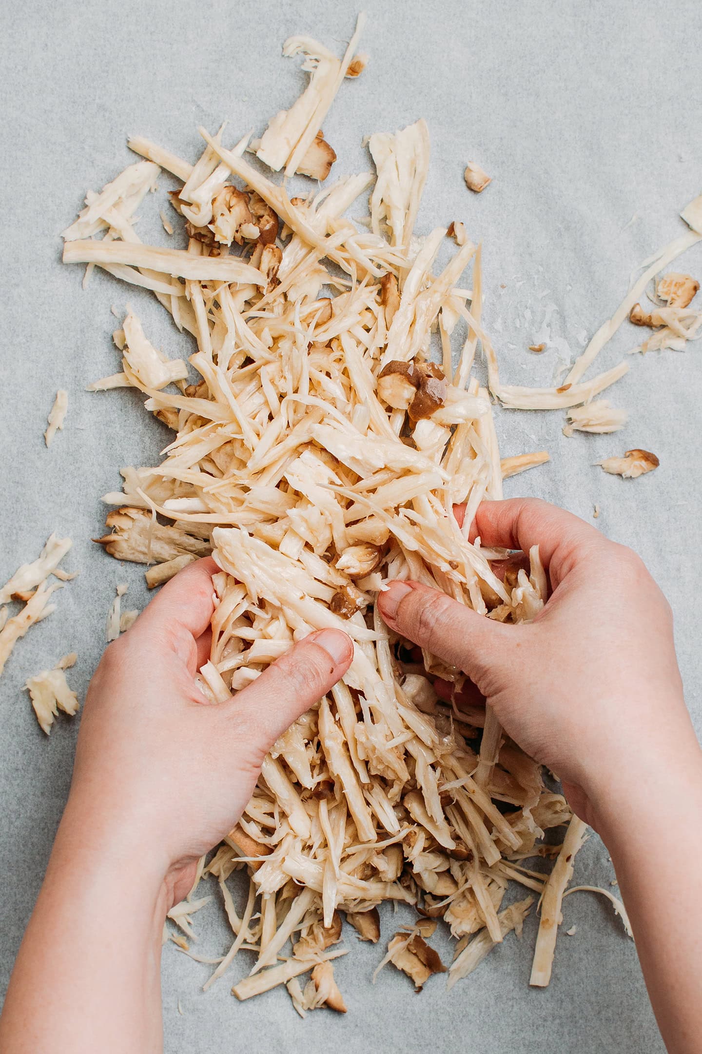 Coating shredded mushrooms with oil.