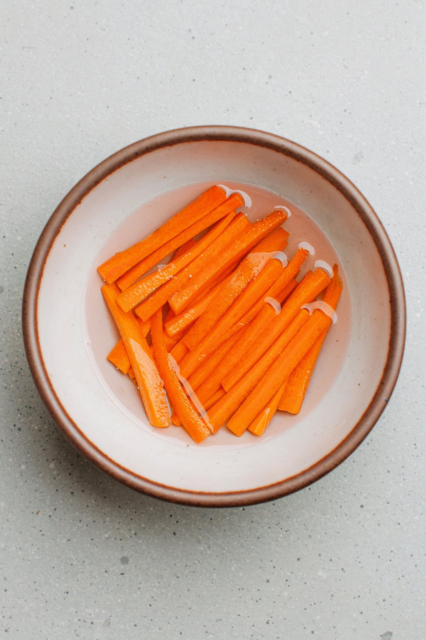 Sliced carrots in a vinegar brine.