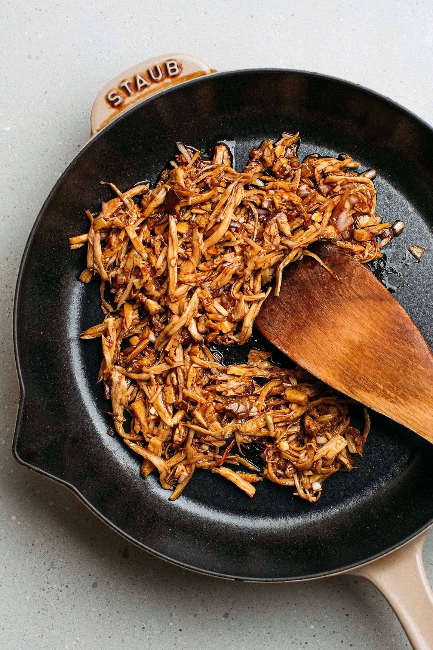 Pulled king oyster mushrooms in a skillet.