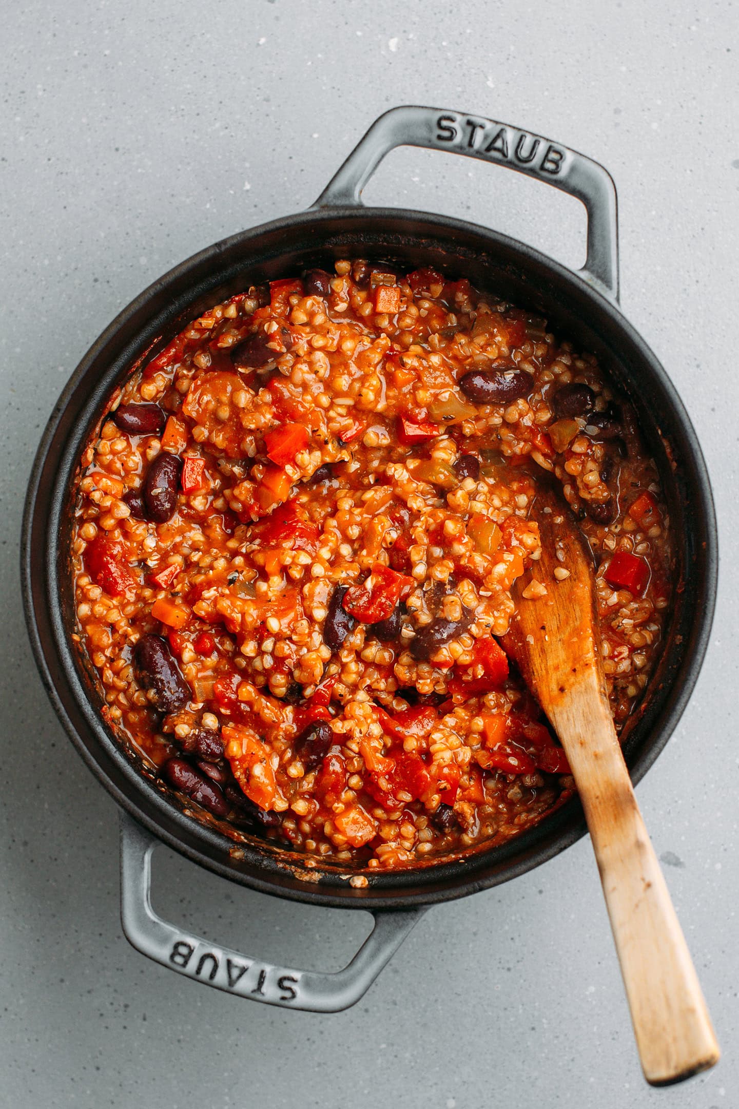 Stirring cooked red beans into a buckwheat chili.