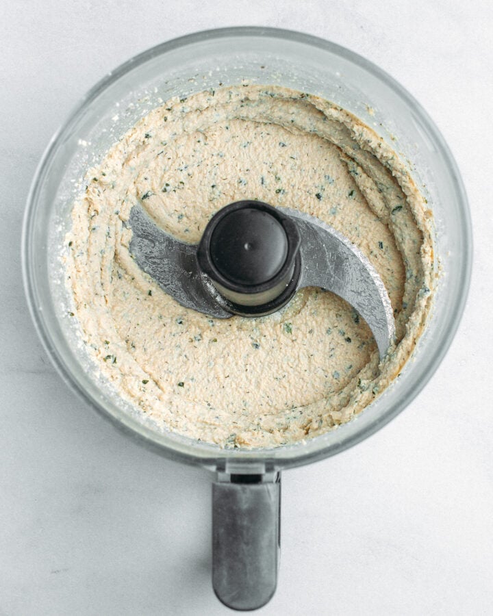 Blended tofu with seasonings in a food processor.