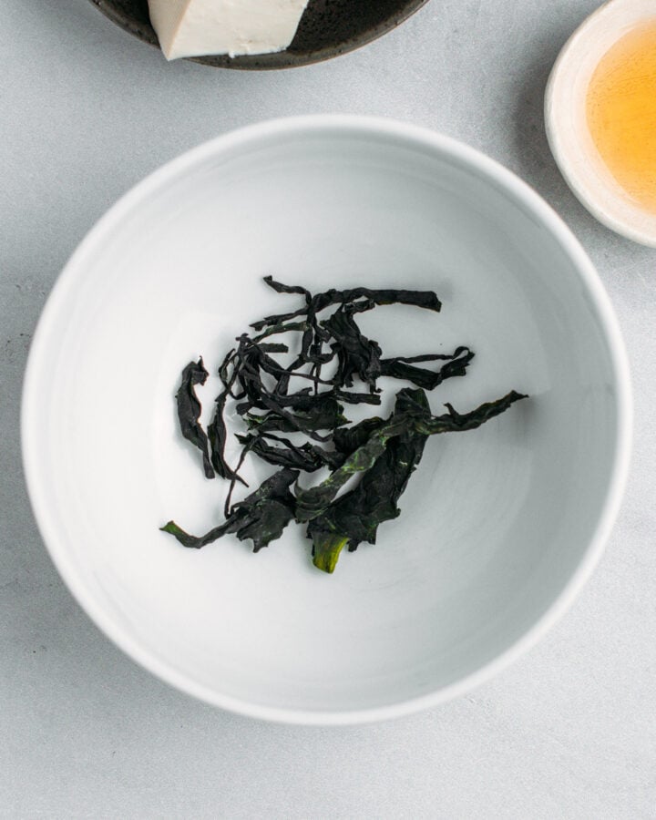 Dried wakame in a small bowl.
