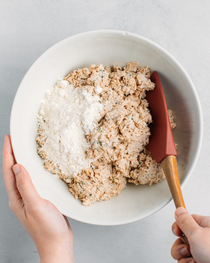 Mixing processed textured vegetable protein and tofu with flour.