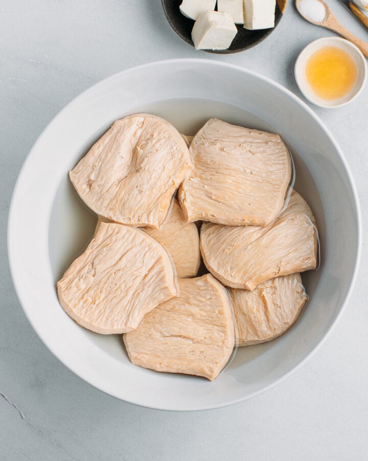 TVP slices soaking in a bowl of water.