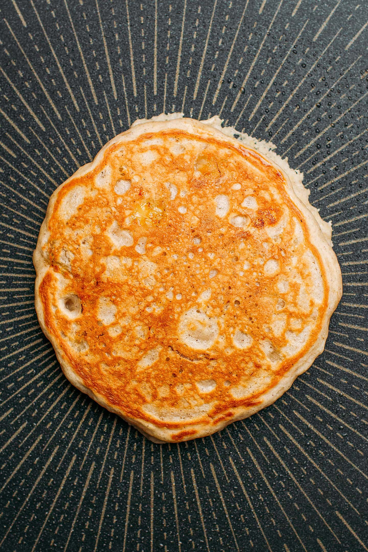 Cooked banana pancake on a skillet.