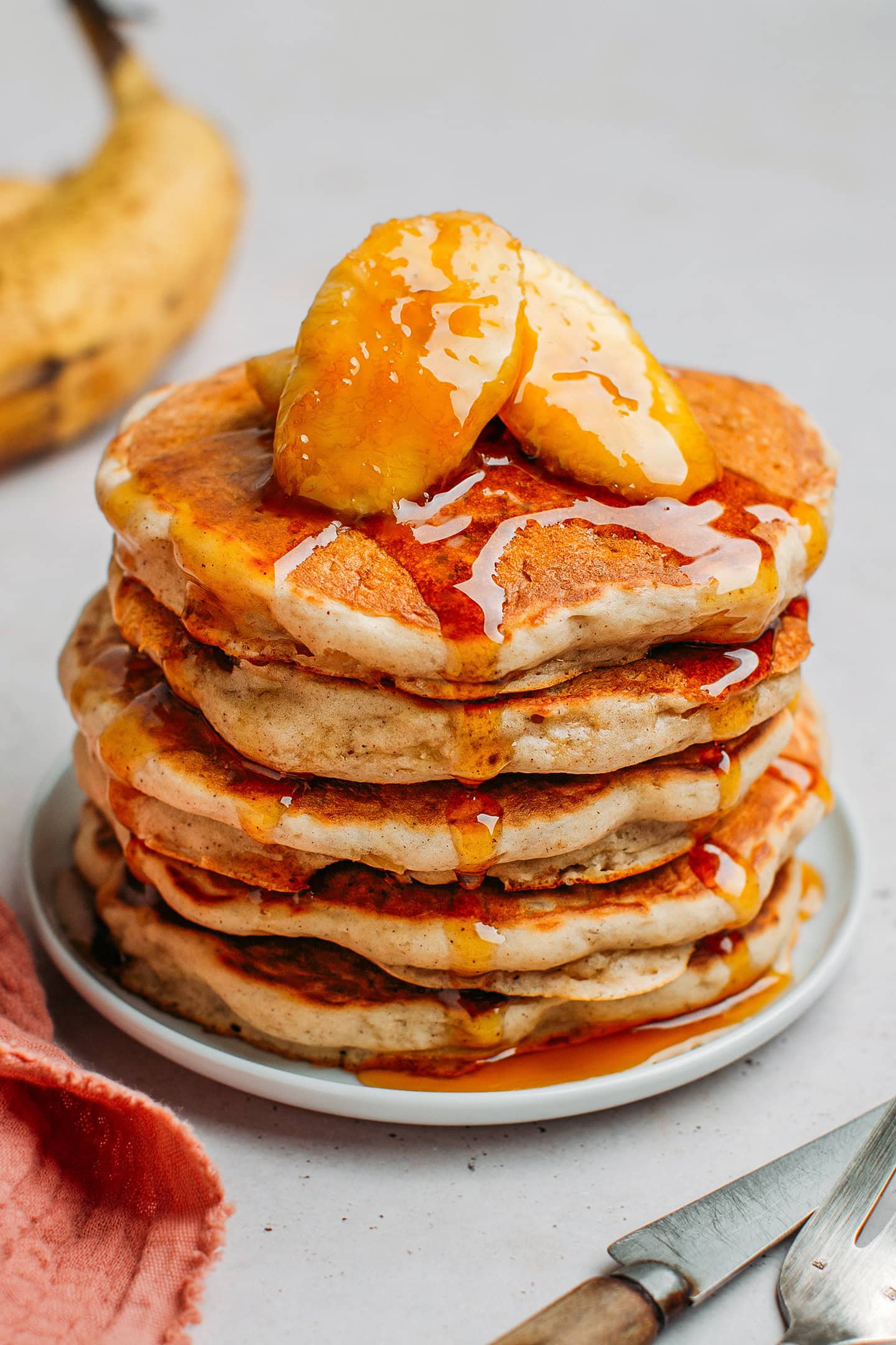 Stack of banana pancakes drizzle with caramel sauce.