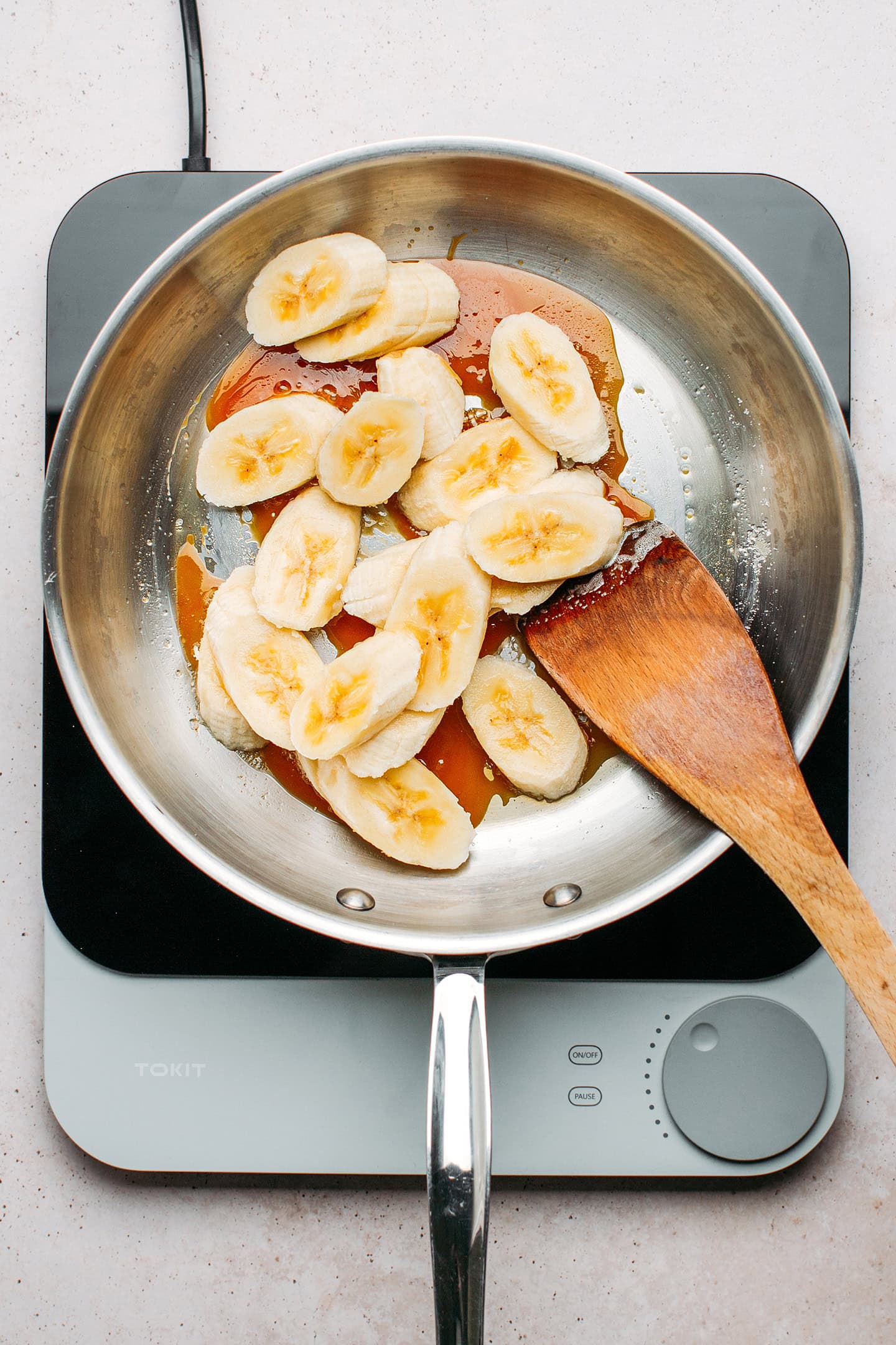 Sliced bananas and caramel in a skillet.