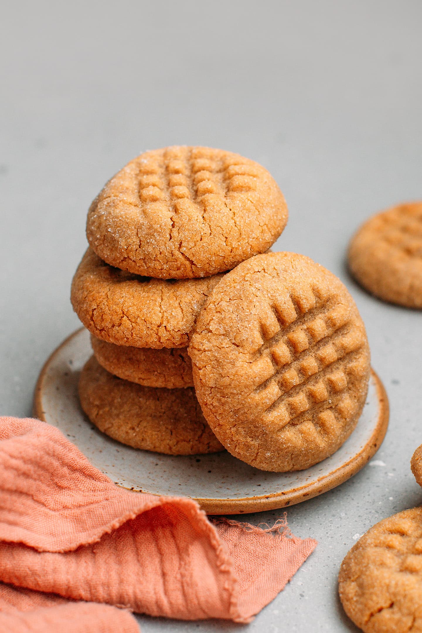 Stack of peanut butter cookies on a small plate.