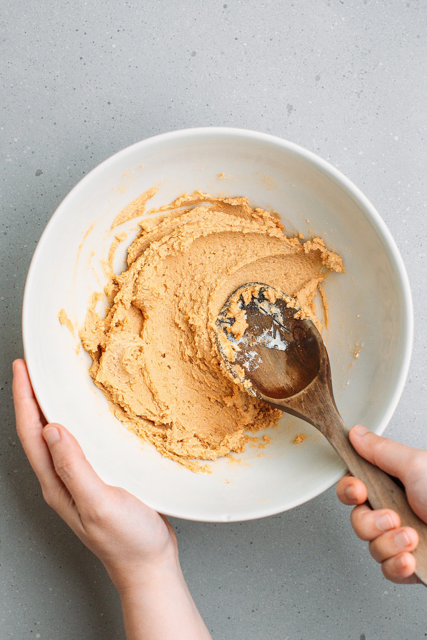 Creaming butter with sugar in a mixing bowl.