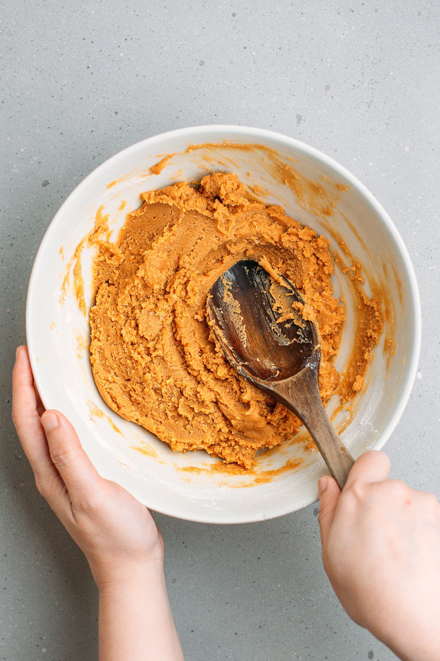 Mixing peanut butter cookie dough in a bowl.