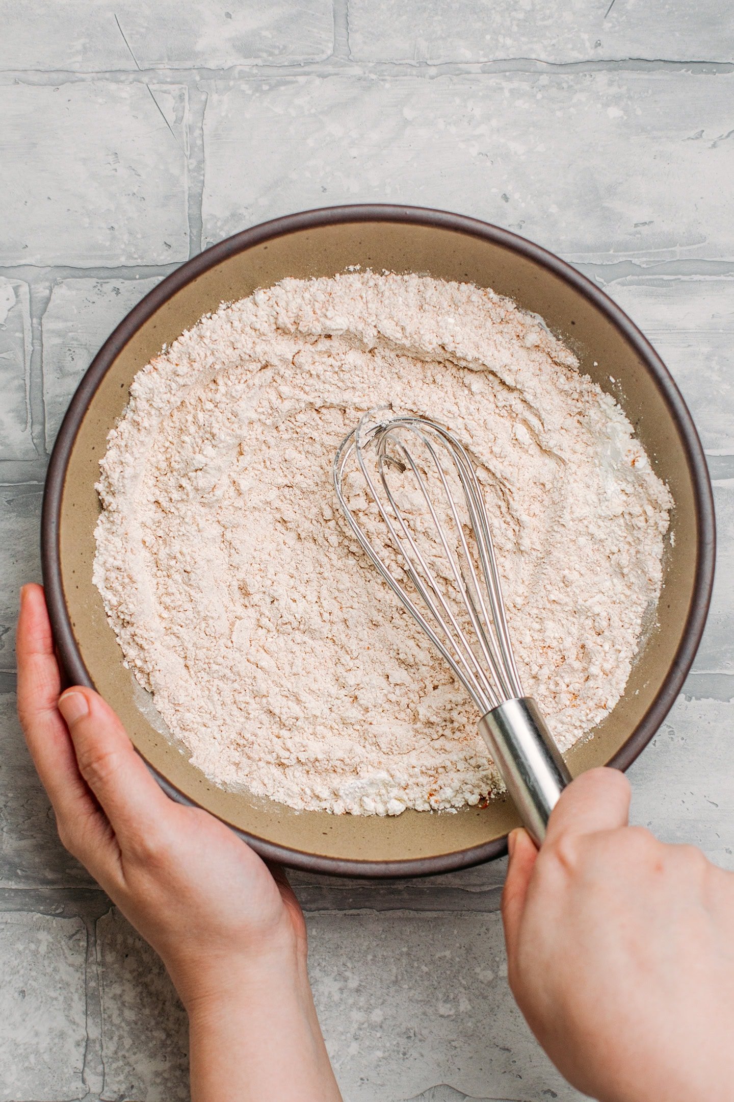 Whisking flour with curry powder and salt.