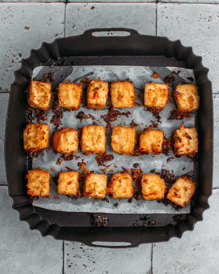Air fried lemongrass tofu in an air fryer basket.