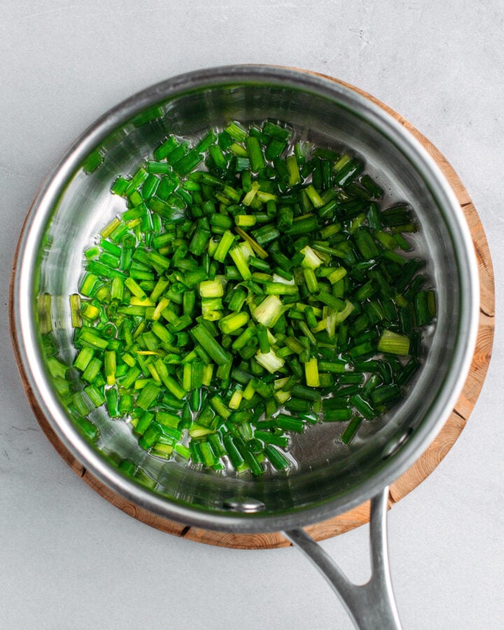 Chopped green onions and oil in a saucepan.