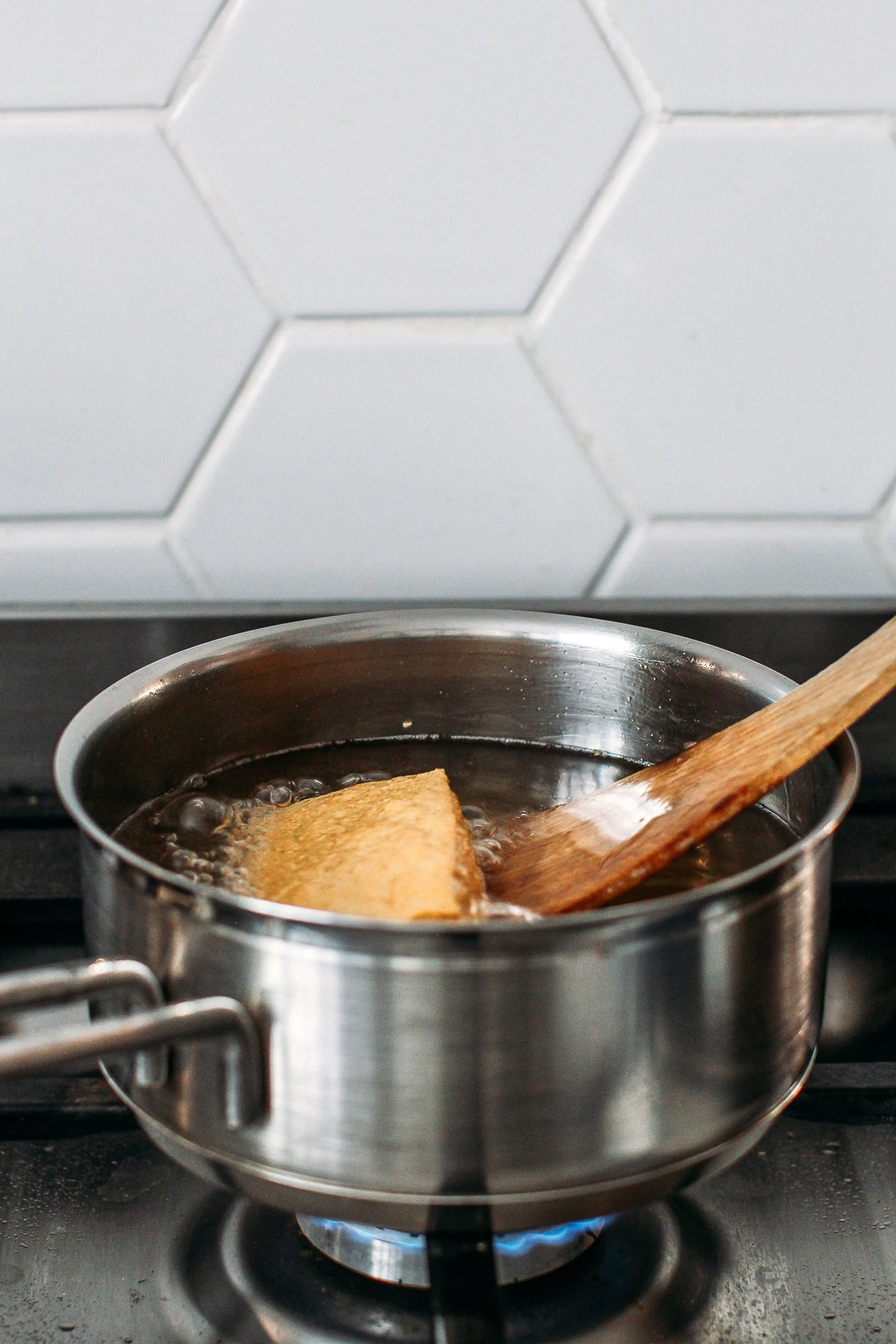 Block of tofu in a pot of oil.