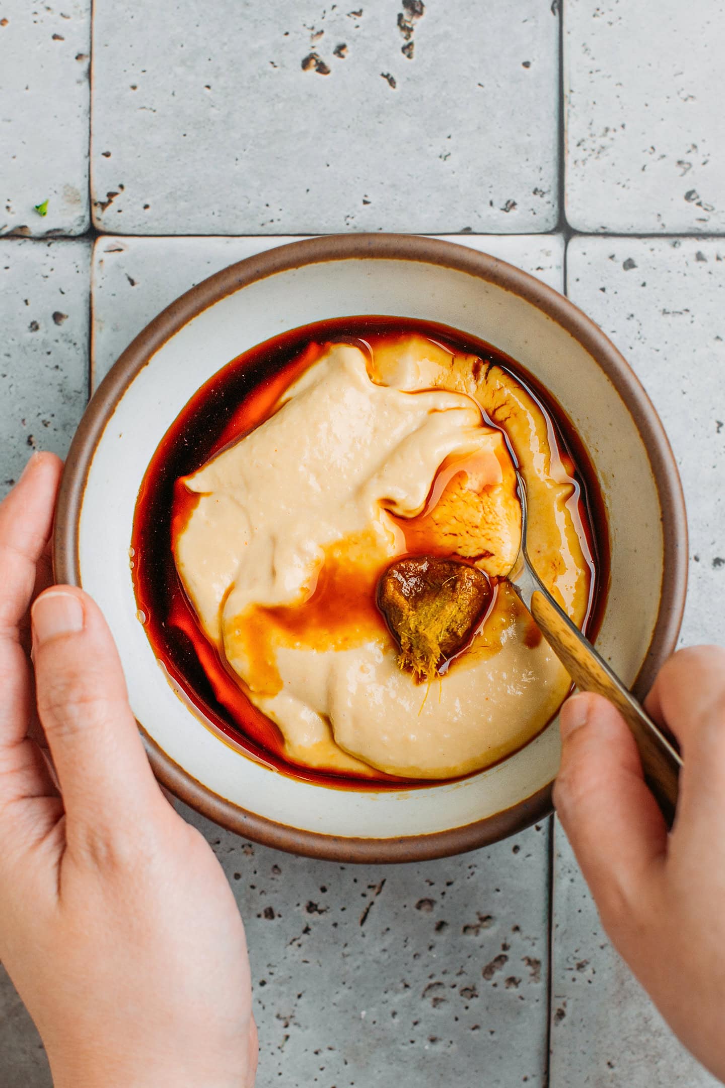 Hummus, soy sauce, and green curry paste in a bowl.