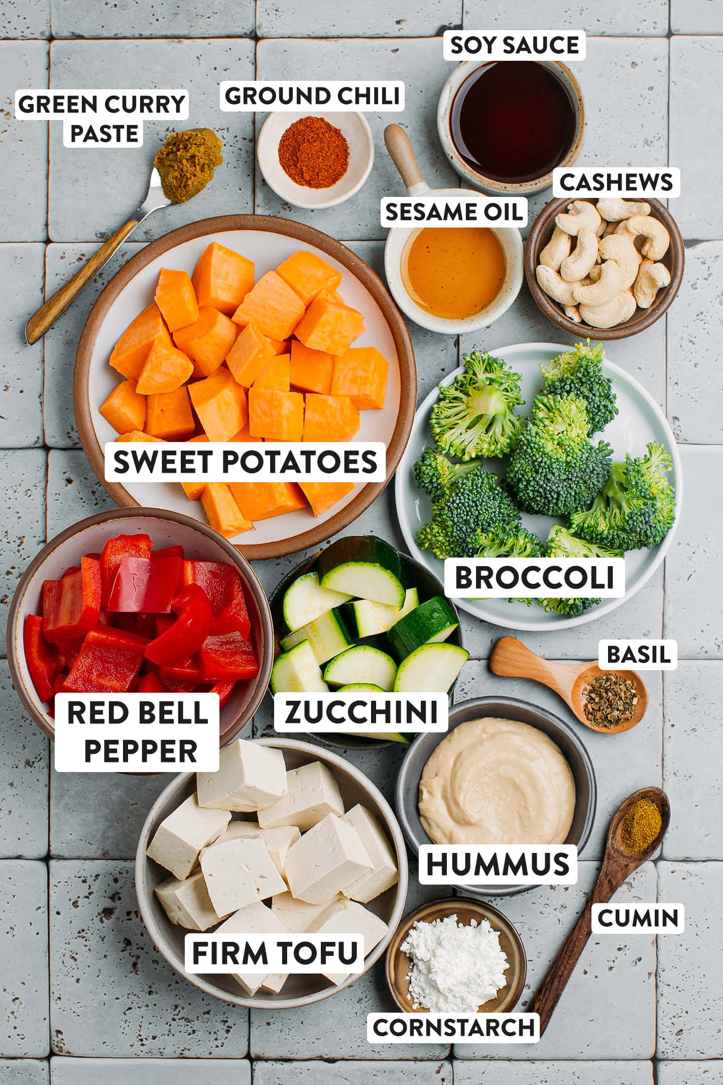 Ingredients like sweet potatoes, red bell peppers, zucchini, and tofu.