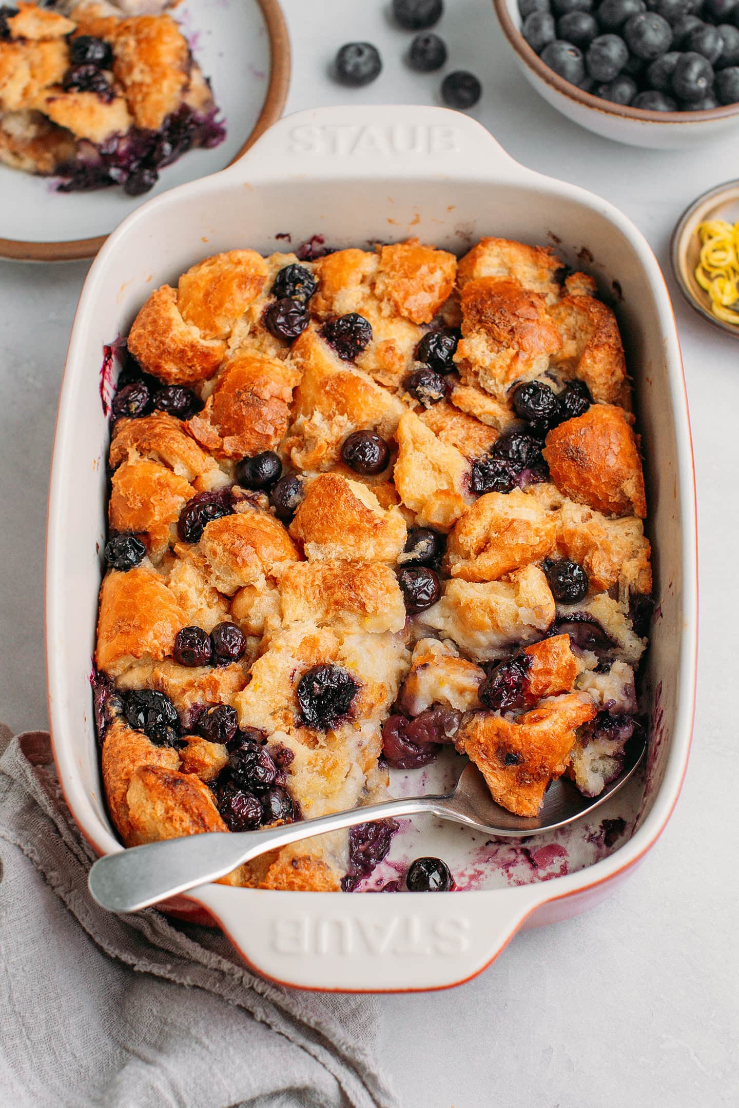 Bread pudding with blueberries in a baking dish.