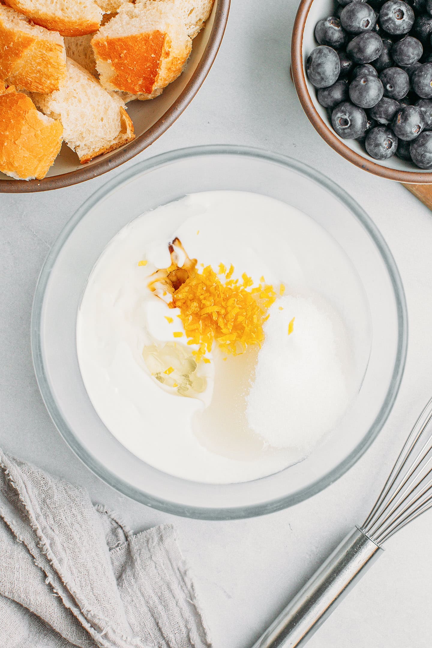 Coconut milk, sugar, oil, and lemon zest in a bowl.