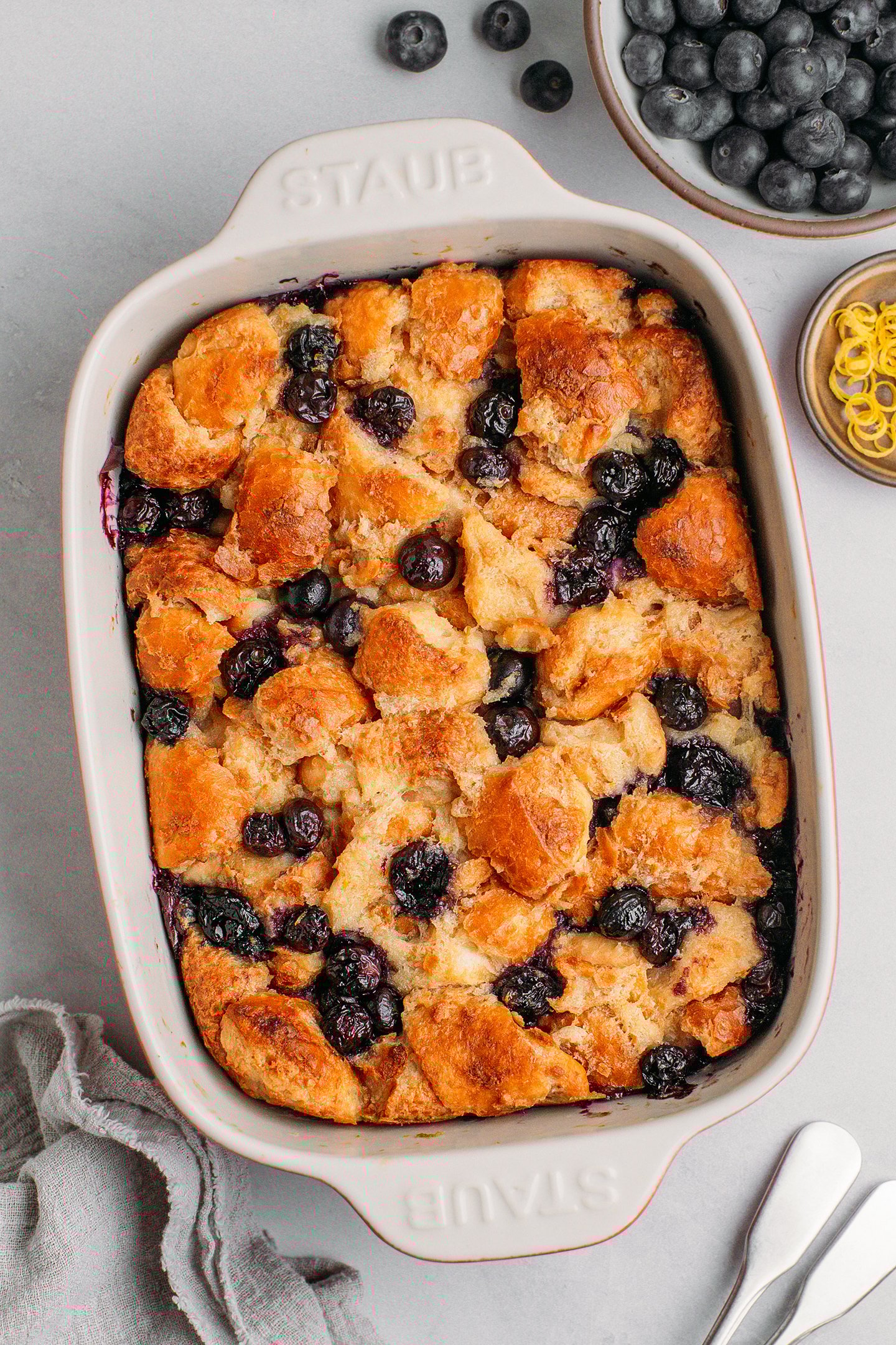 Baked blueberry bread pudding in a baking dish.
