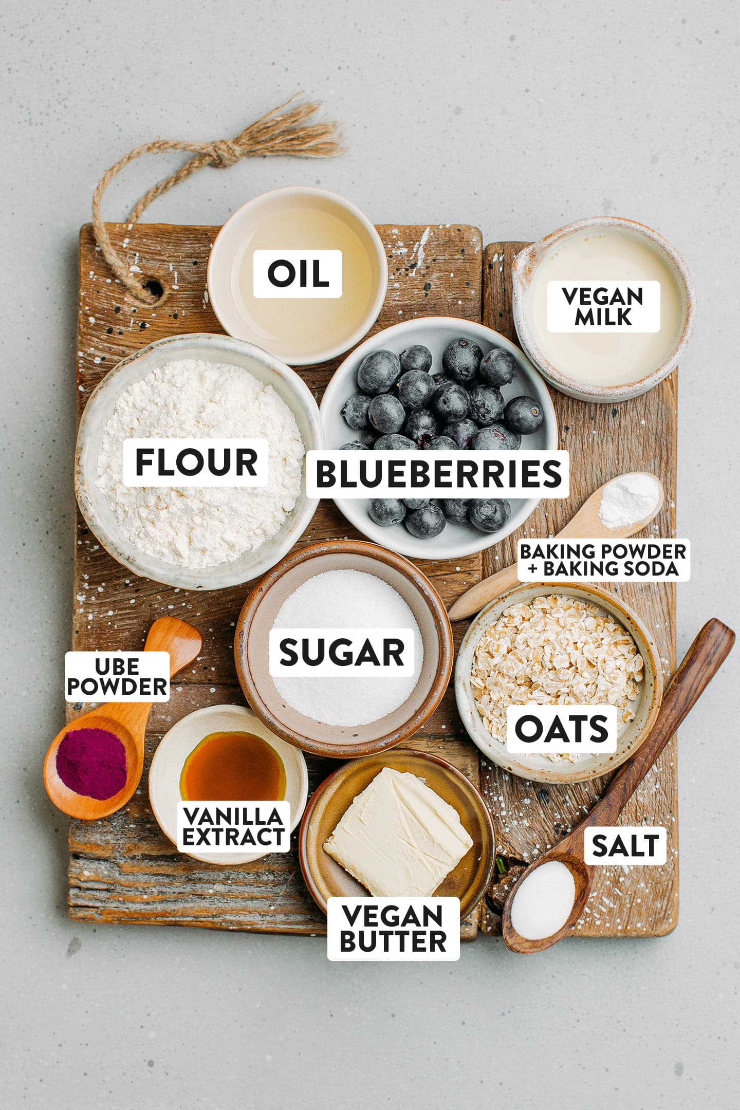 Ingredients like flour, sugar, oats, butter, vanilla extract, and blueberries.