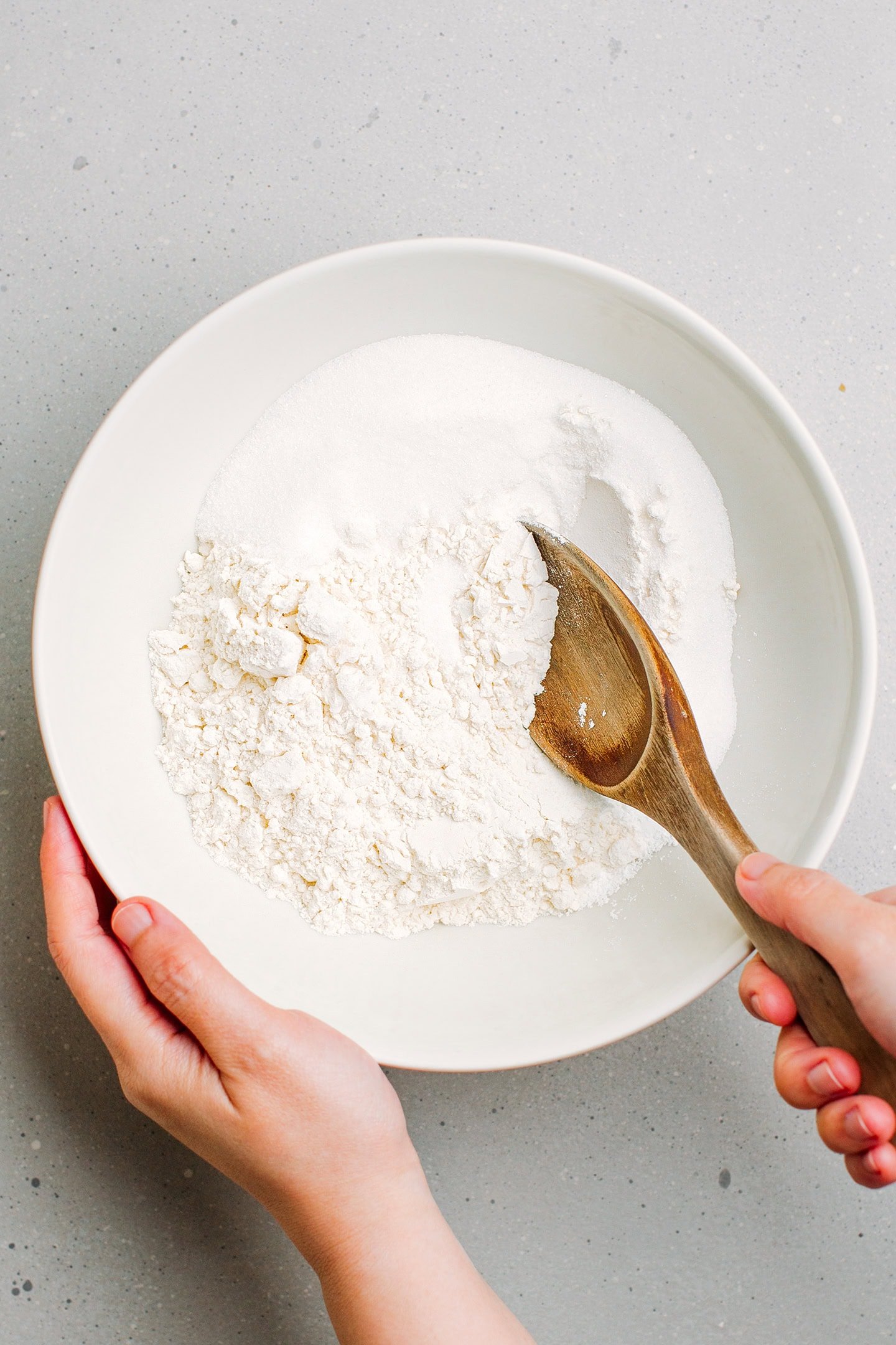Flour, sugar, and baking powder in a mixing bowl.