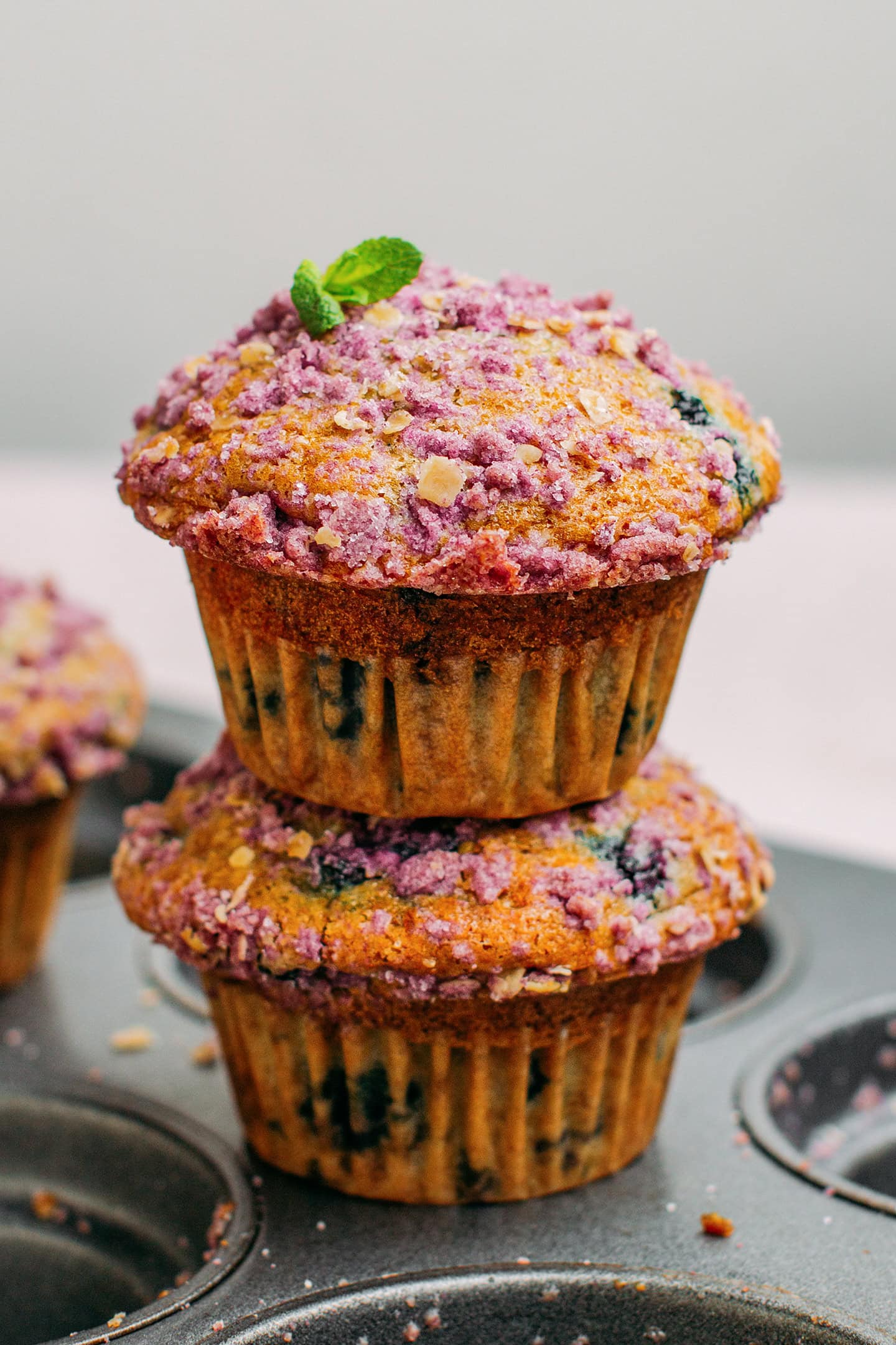 Two blueberry muffins stacked.