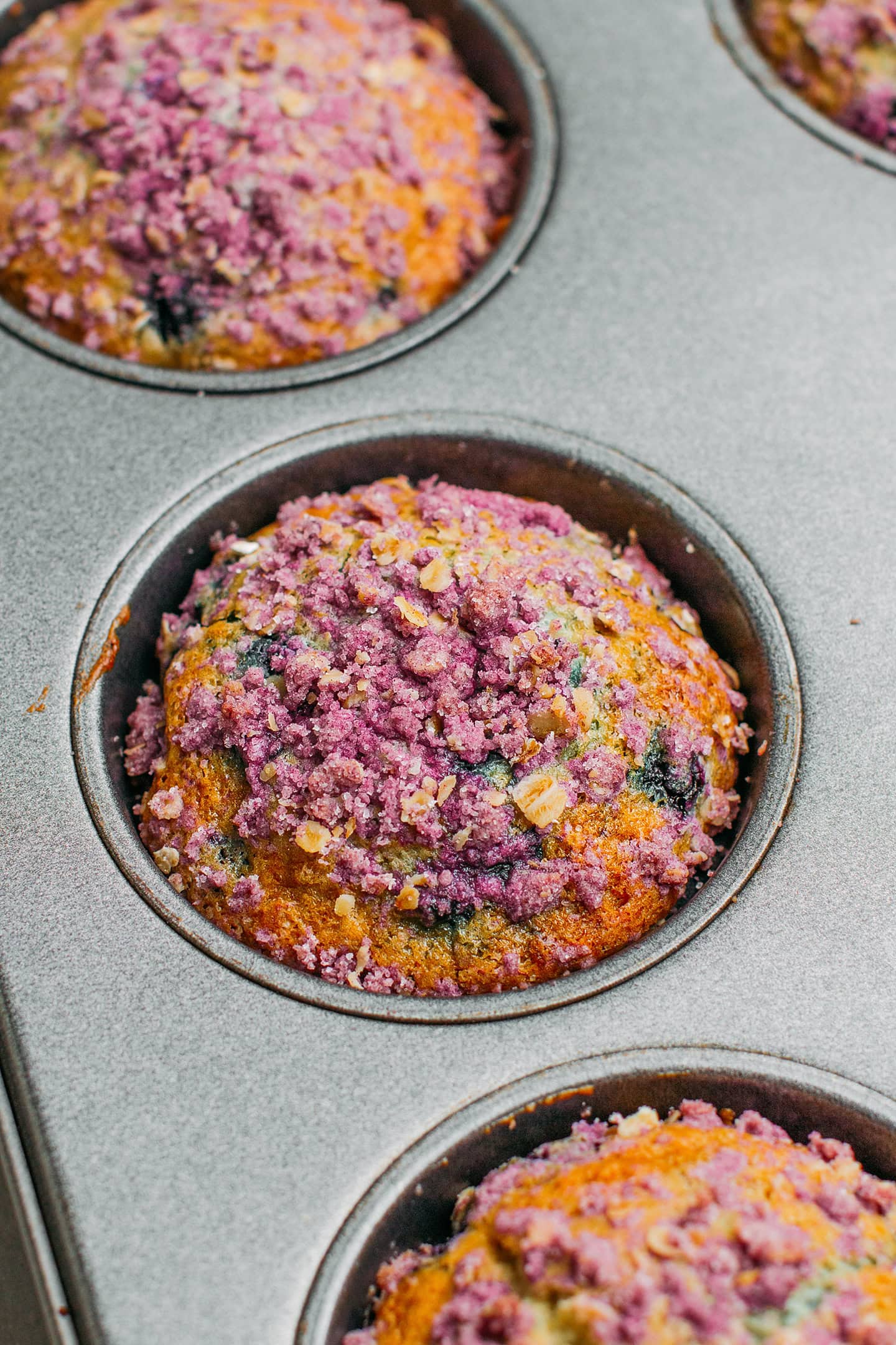 Baked blueberry muffin in a pan.