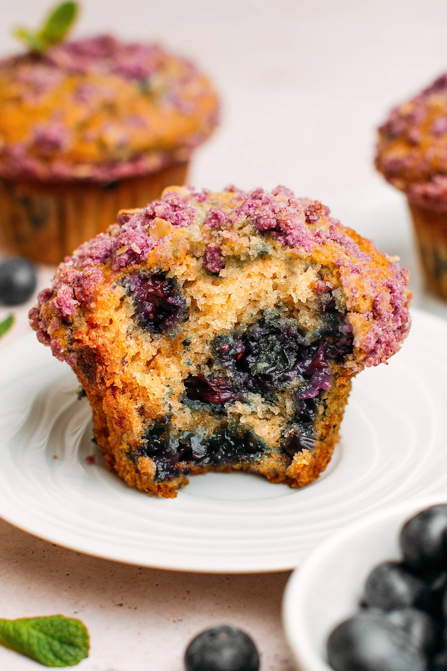 Close-up of a bite of a blueberry muffin.