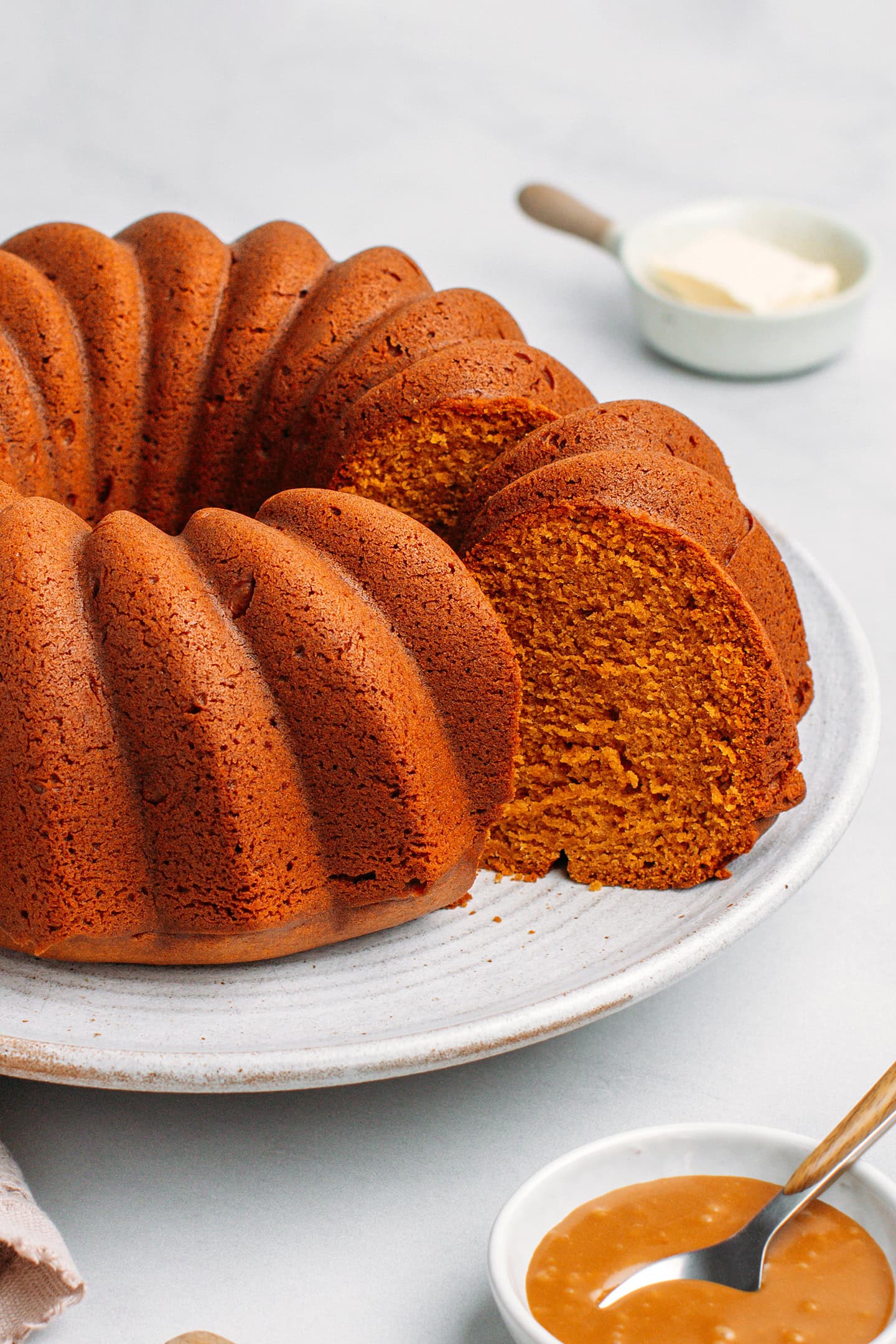 Slice of caramel pound cake on a white plate.