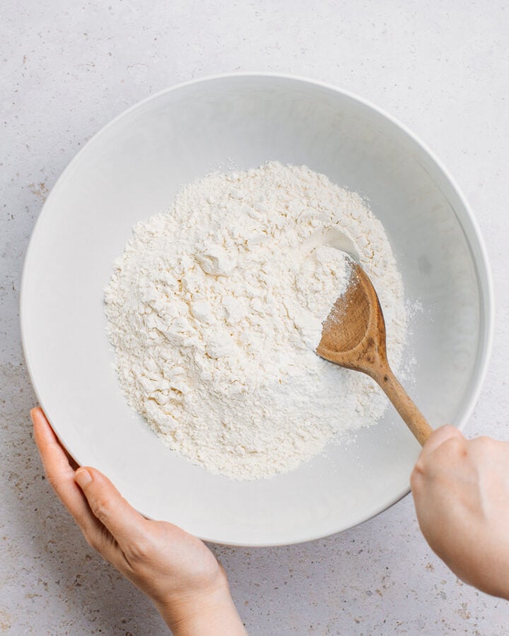 Mixing flour, baking powder, and salt in a mixing bowl.