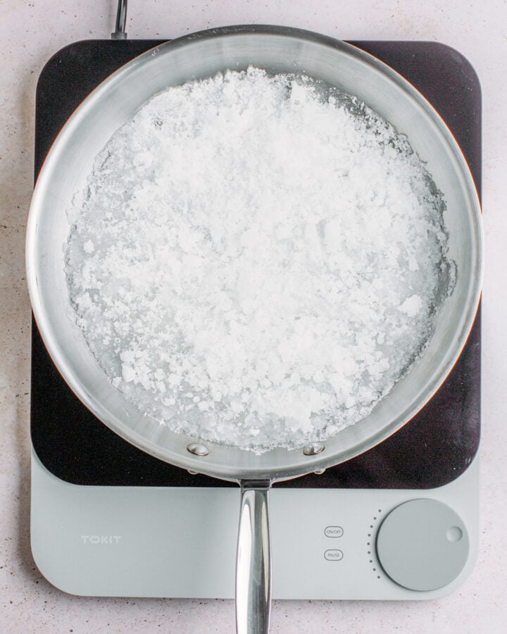 Sugar melting in a large pan.