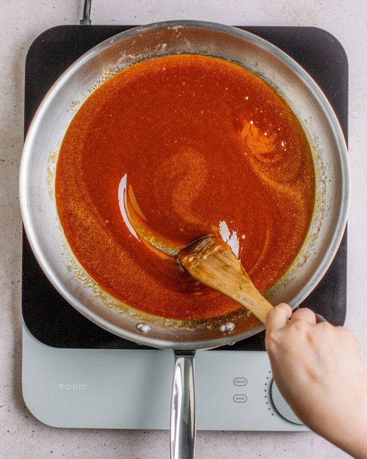 Stirring caramel in a large pan.