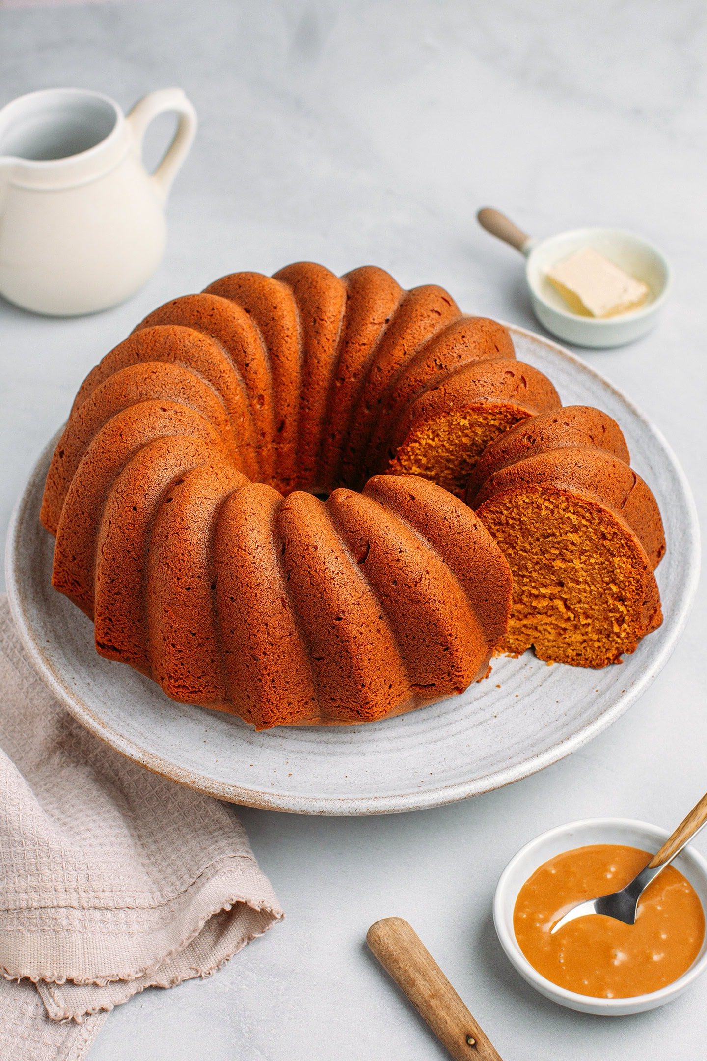 Caramel bundt cake on a large plate.