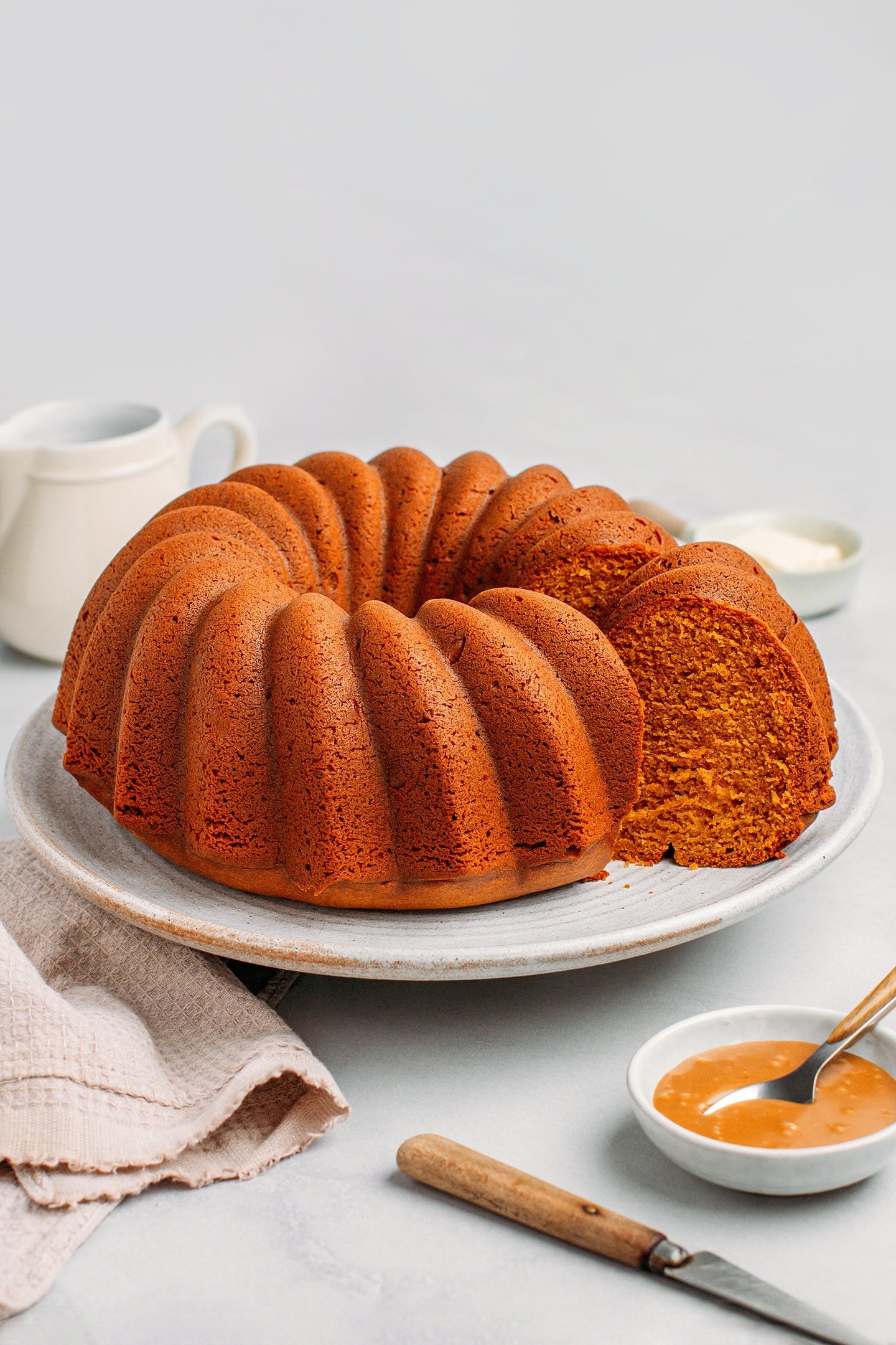 Caramel pound cake sliced on a large serving plate.