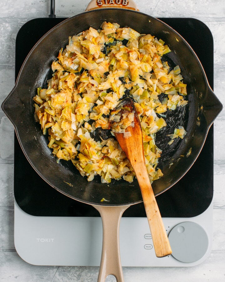 Sautéed caramelized leeks in a skillet.