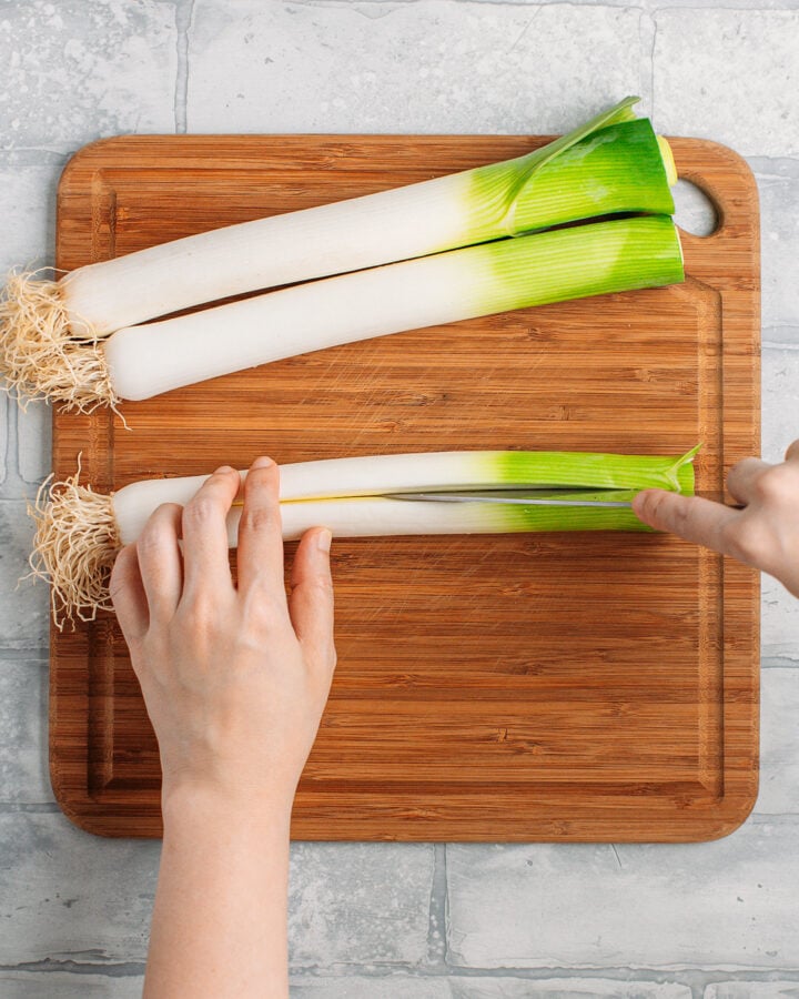 Slicing a leek in half lengthwise.