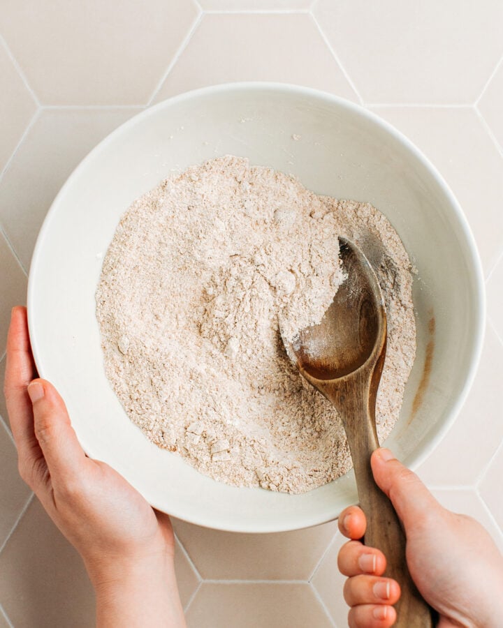 Whisking flour, brown sugar, and baking powder in a mixing bowl.