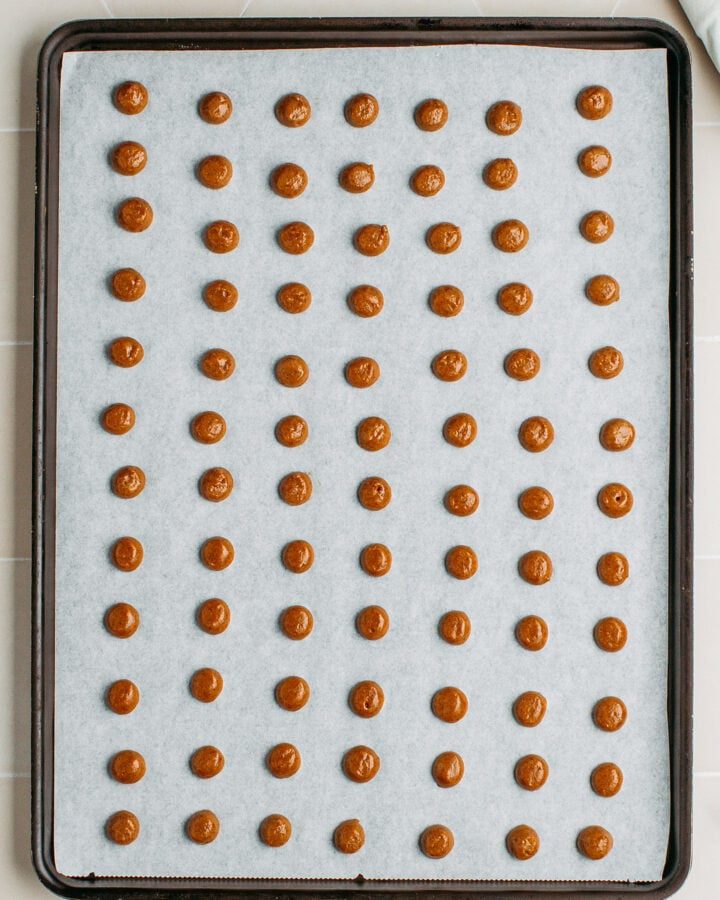 Unbaked mini cinnamon cereal on a baking sheet.