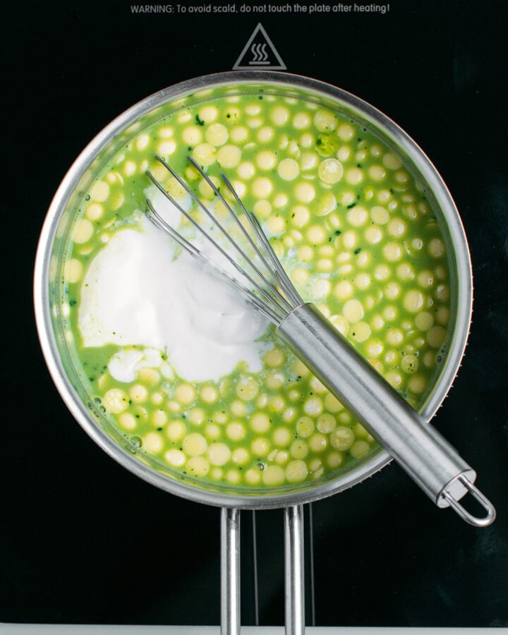 Milk, matcha, cocoa butter, and coconut cream in a saucepan.