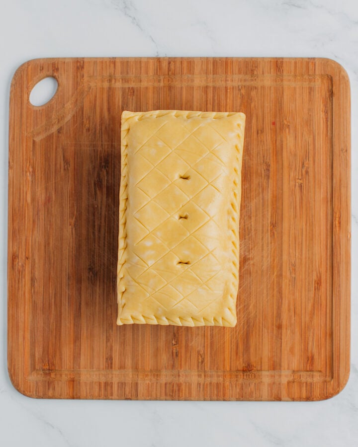 Top view of vegan pâté en croute in a rectangular pan before baking.