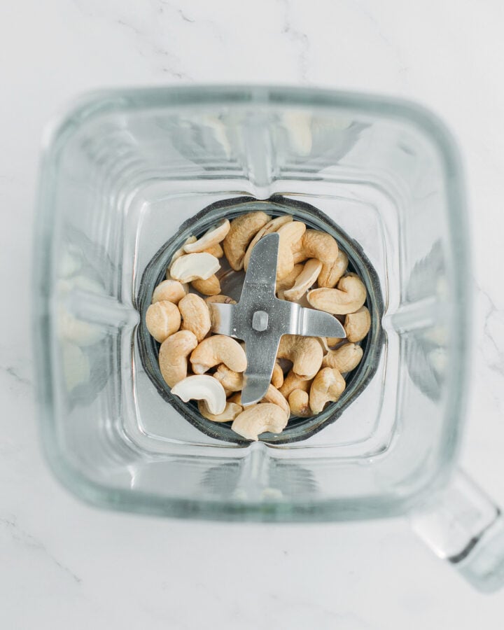 Raw cashews in a blender.