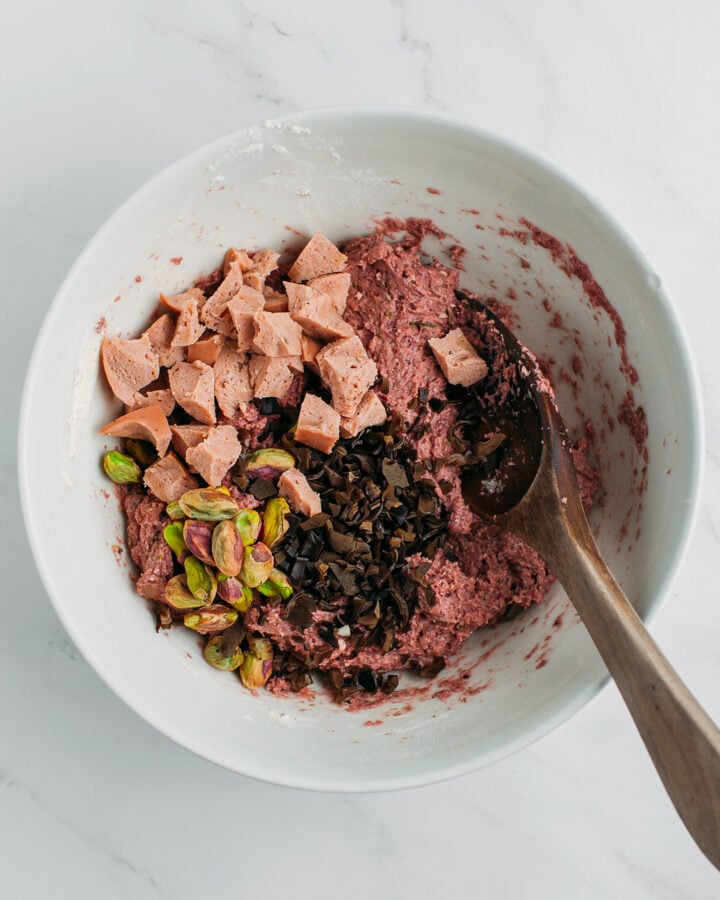 Mushroom paste, pistachios, vegan bologna, and black mushrooms in a mixing bowl.