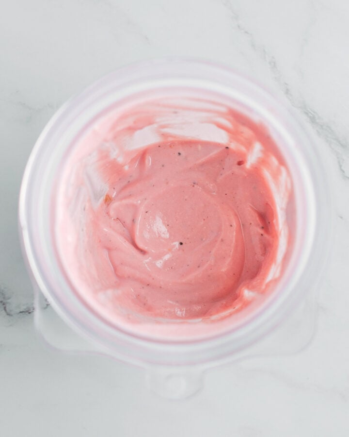 Blended tofu with seasonings and red food coloring in a blender.