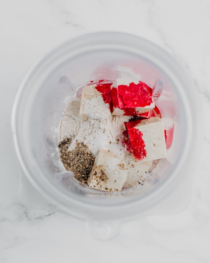 Tofu, water, black pepper, salt, and red food coloring in a blender.