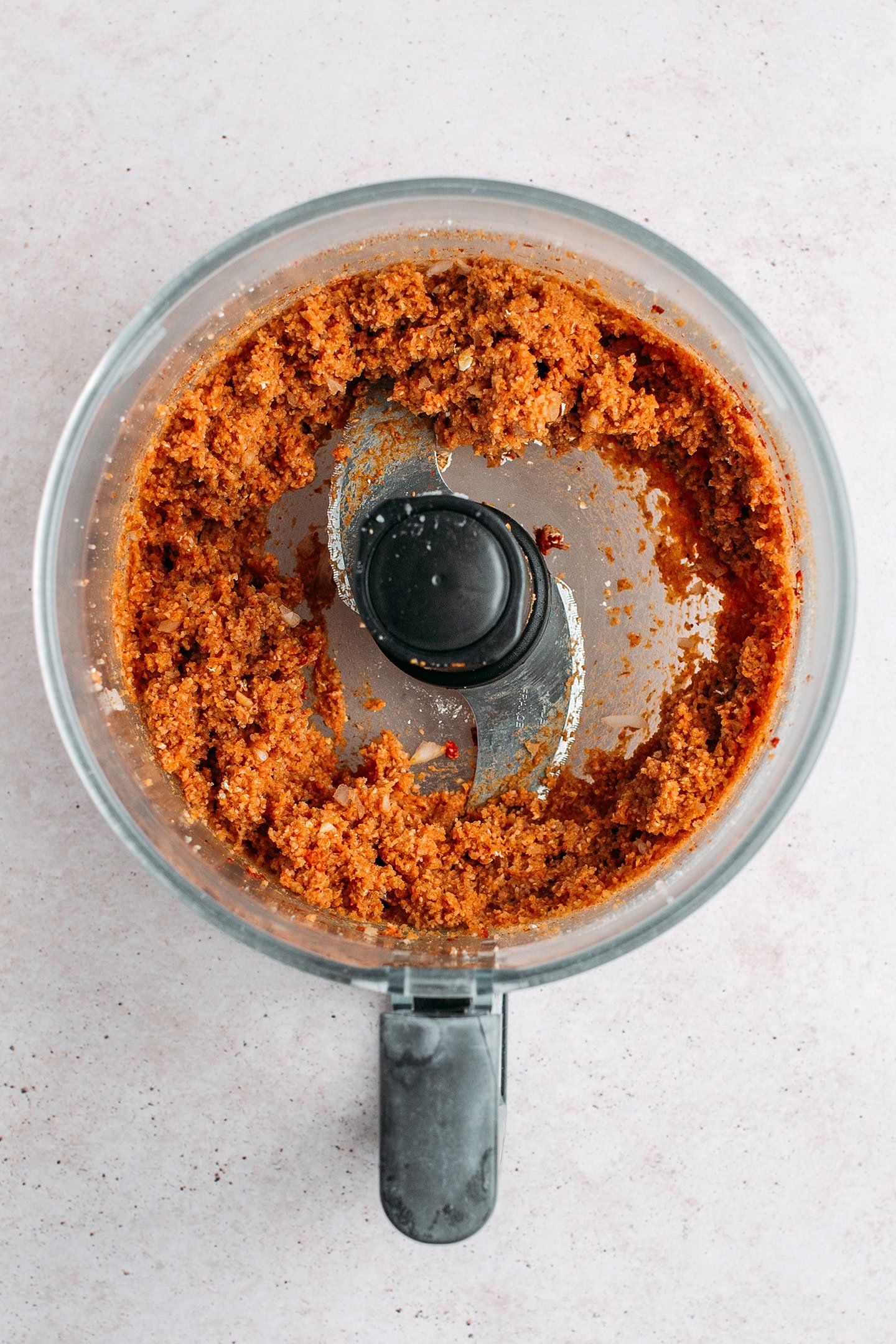 Processed fonio and seasonings in a food processor.