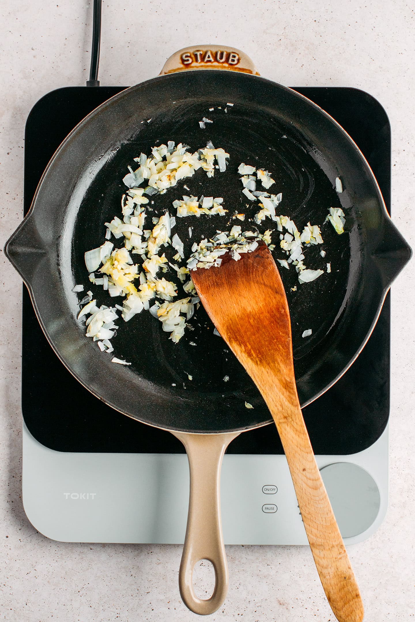Sautéed ginger, garlic, and onion in a skillet.
